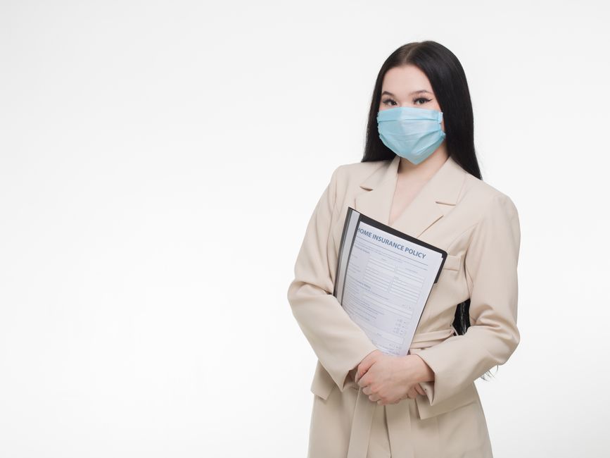 Insurance professional holding a health insurance document explaining in-network vs out-of-network terms